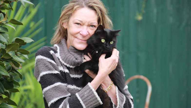 Photograph of Kelly, who received pro bono legal help, and her cat.