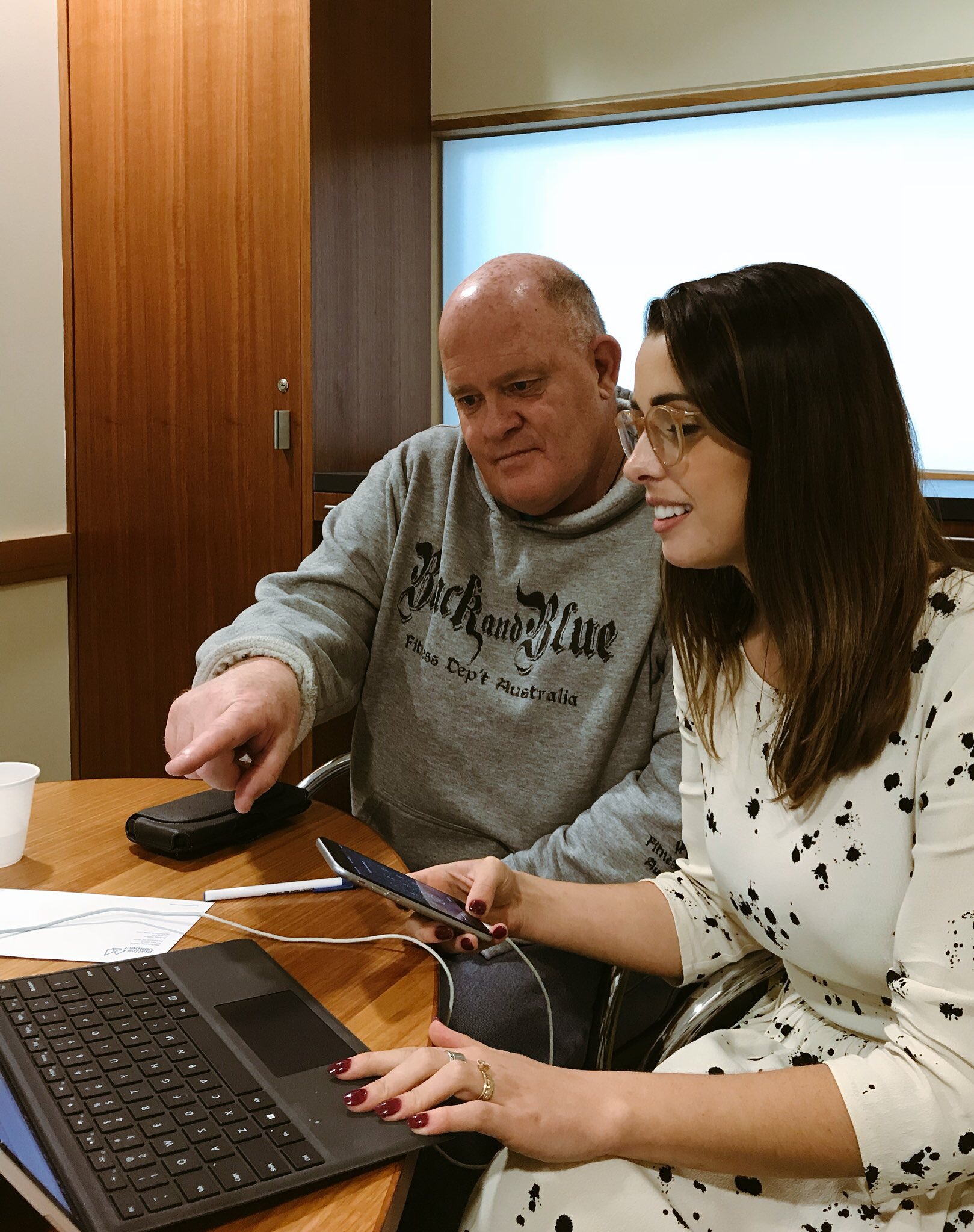 Justice Connect employees pictured looking at a laptop,